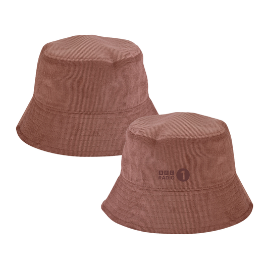 Two views of the BBC Radio 1 Radio 1's Big Weekend 2026 Bucket Hat in brown: one plain front, the other featuring the BBC Radio 1 logo. The hat has a wide brim and soft, textured corduroy fabric.