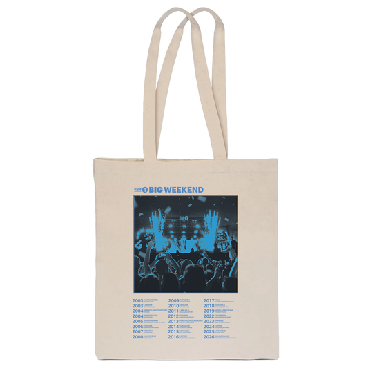 The BBC Radio 1 Radio 1's Big Weekend Cities Tote Bag Natural is a beige bag with long handles, featuring a blue concert crowd and stage image. Above it reads “BBC BIG WEEKEND,” with event years from 2003 to 2023 below.